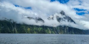 An Awesome Day in Milford Sound featured image with cloud-covered mountains