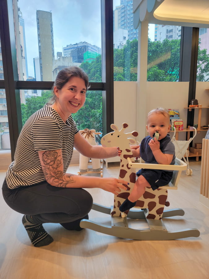 Becky and Micah at play cafe in Hong Kong Becky and Micah at play cafe with baby on rocking horse